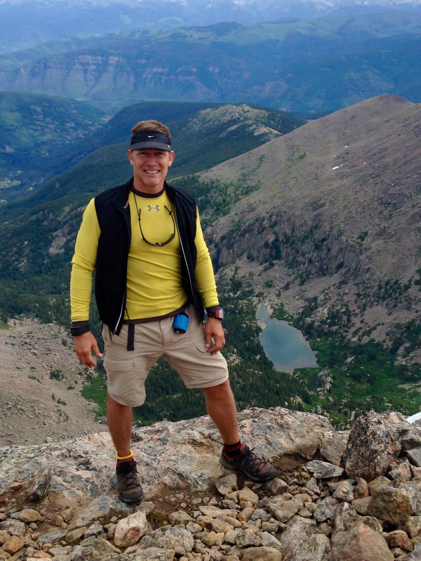 Don standing high on Mount of the Holy Cross with the basin and lake far below