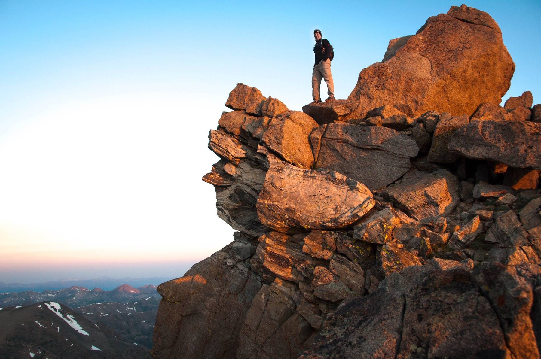 Don standing on a sunlit rocky outcropping high on Mount Massive